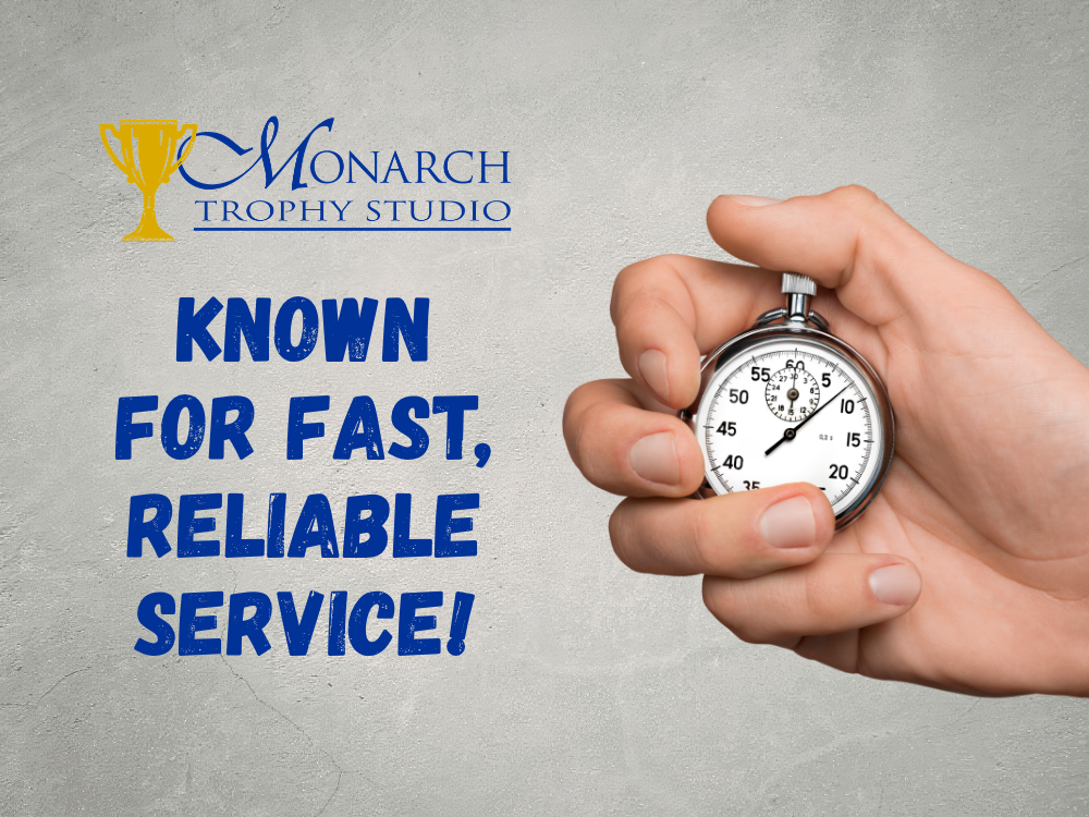 Hand holding stopwatch beside Monarch Trophy Studio logo, highlighting fast, reliable service for custom trophies.